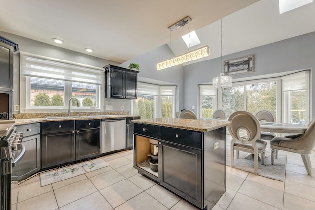 kitchen featuring a sink, light stone counters, dark cabinetry, stainless steel appliances, and light tile patterned floors