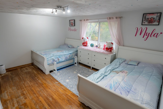 4468 15 Mile Rd Unit 104, Sterling Heights, MI 48310 - bedroom featuring baseboards and wood finished floors