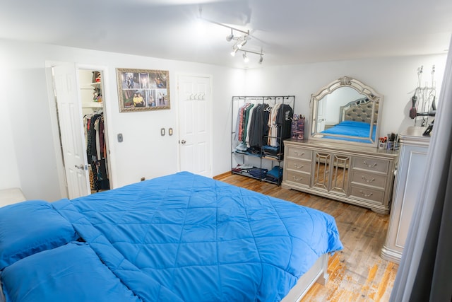 4468 15 Mile Rd Unit 104, Sterling Heights, MI 48310 - bedroom featuring wood finished floors and a spacious closet