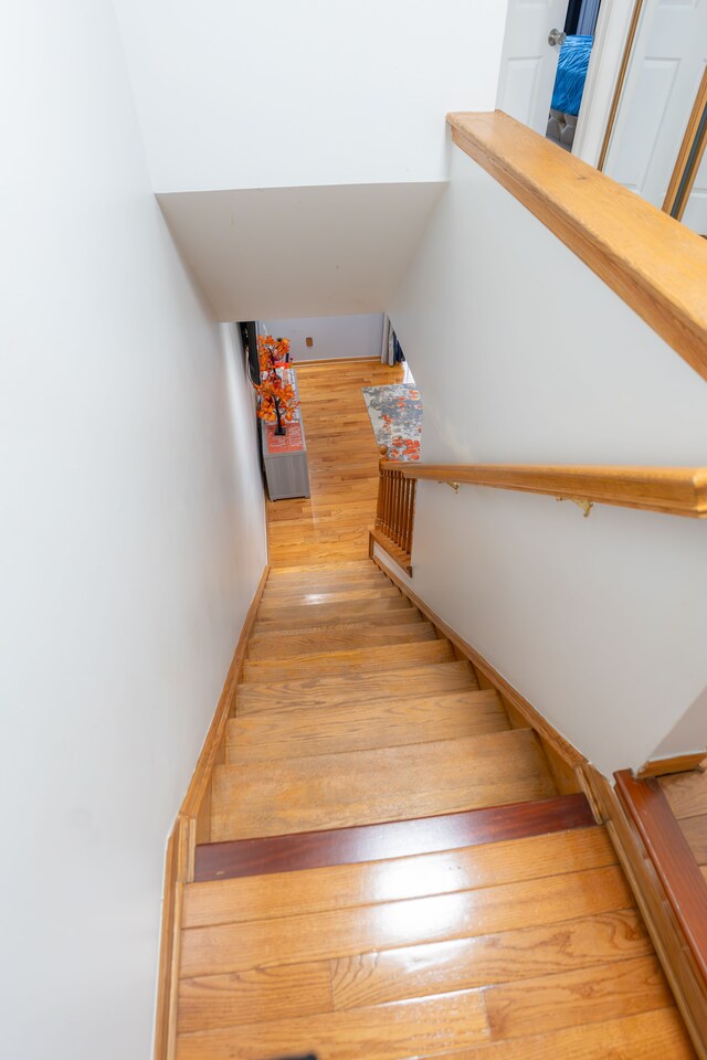 4468 15 Mile Rd Unit 104, Sterling Heights, MI 48310 - stairway with hardwood / wood-style flooring and baseboards