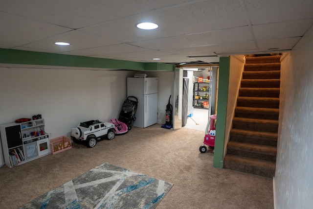 4468 15 Mile Rd Unit 104, Sterling Heights, MI 48310 - finished below grade area with freestanding refrigerator, carpet, stairs, and a paneled ceiling