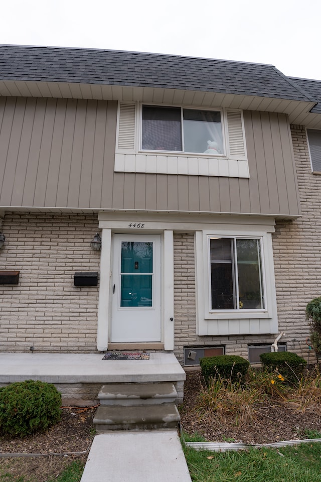 4468 15 Mile Rd Unit 104, Sterling Heights, MI 48310 - entrance to property with brick siding and a shingled roof