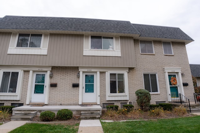 4468 15 Mile Rd Unit 104, Sterling Heights, MI 48310 - view of front of house featuring a shingled roof and brick siding