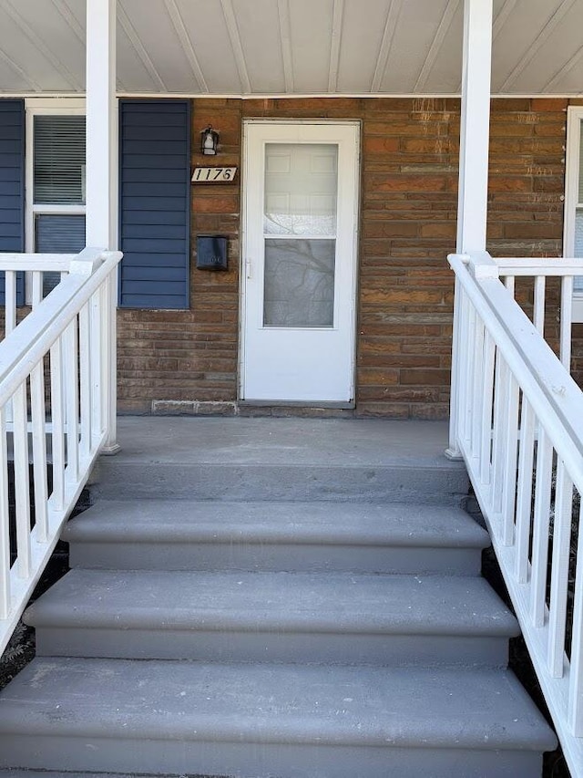 view of exterior entry featuring a porch