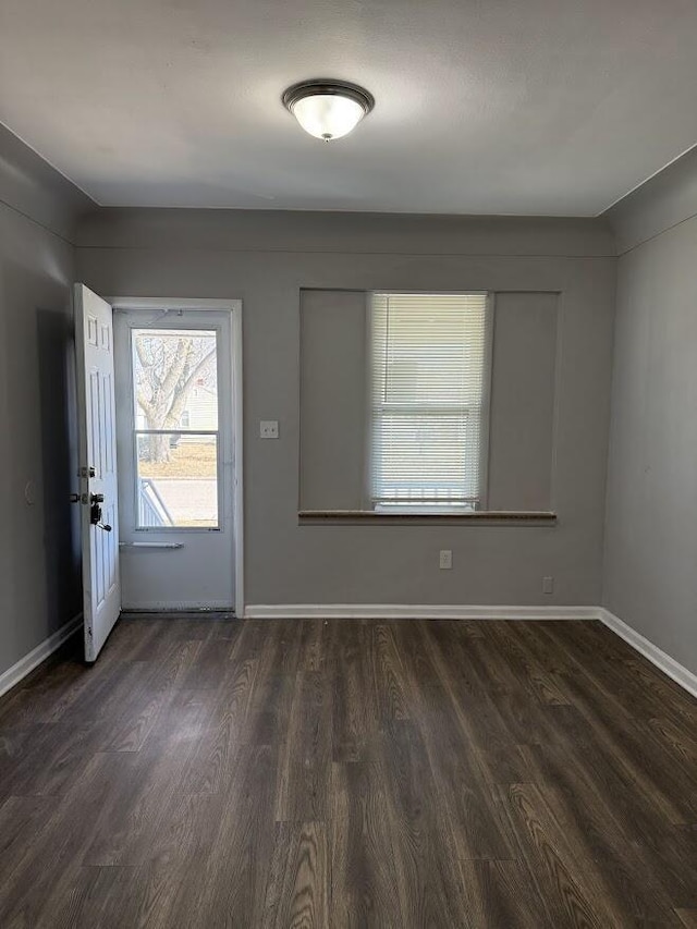 foyer with baseboards and wood finished floors