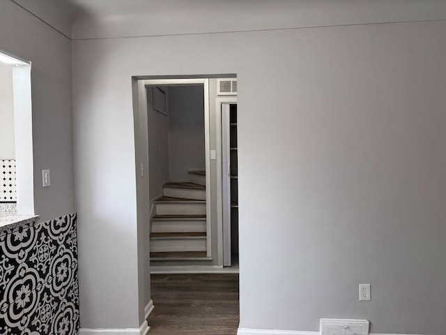 hall with wood finished floors and visible vents