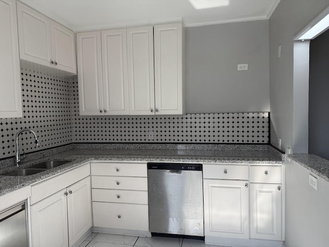 kitchen featuring marble finish floor, a sink, stainless steel dishwasher, white cabinetry, and light stone countertops