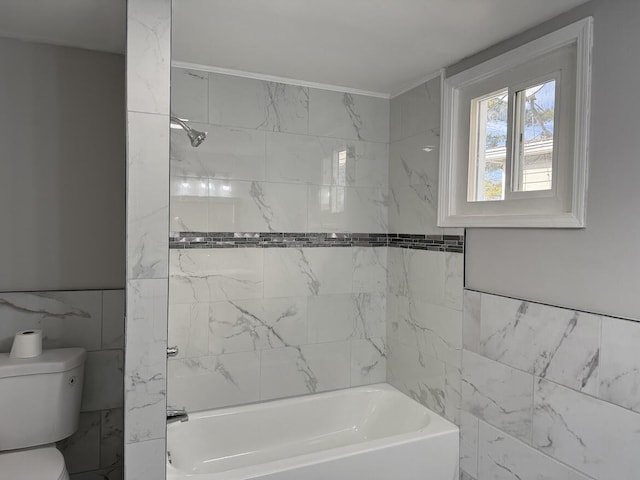 full bath featuring tile walls, toilet, and shower / bathing tub combination