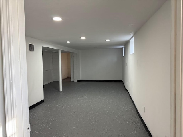 below grade area featuring recessed lighting, visible vents, and baseboards