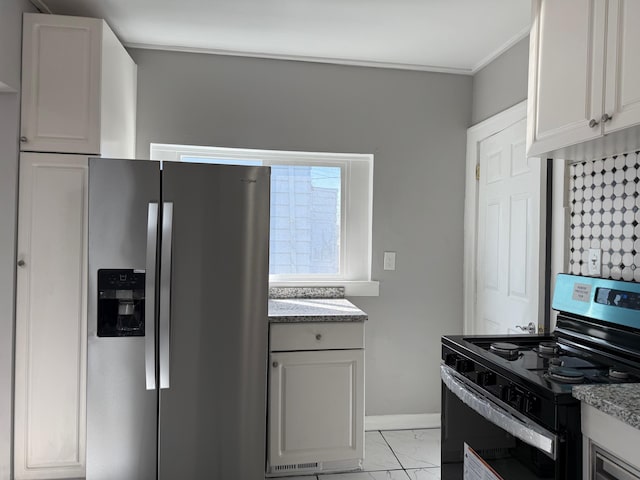 kitchen with marble finish floor, light stone counters, black range with electric cooktop, stainless steel fridge, and baseboards