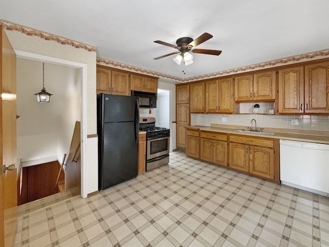 kitchen with light floors, a sink, black appliances, light countertops, and brown cabinets