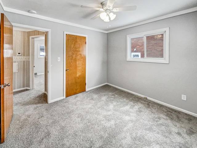 unfurnished room featuring baseboards, carpet, and a ceiling fan