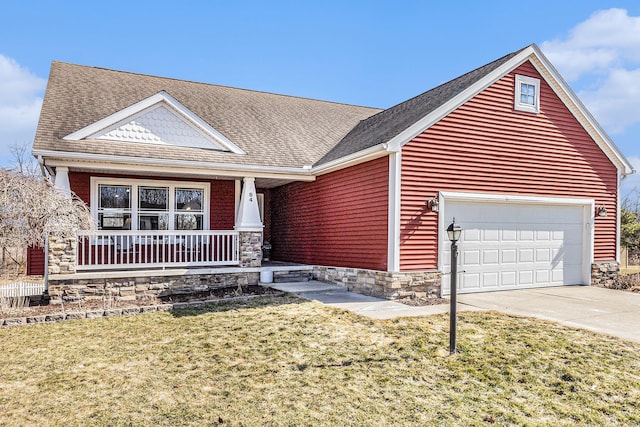 view of front of home featuring a front lawn, a porch, driveway, stone siding, and an attached garage