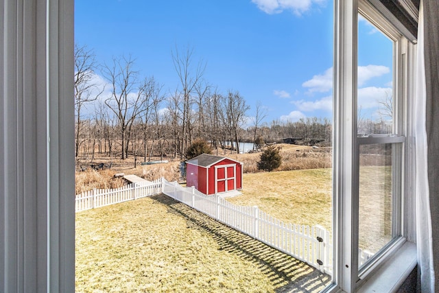 view of yard with a fenced backyard, a shed, and an outdoor structure