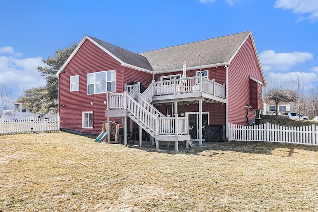 back of house with stairs, a lawn, a fenced backyard, and a wooden deck