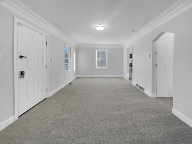 interior space with visible vents, baseboards, and ornamental molding