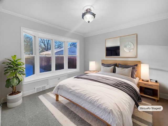 bedroom featuring baseboards, visible vents, and ornamental molding