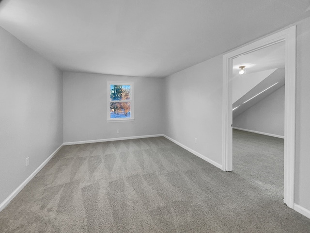 empty room featuring carpet and baseboards