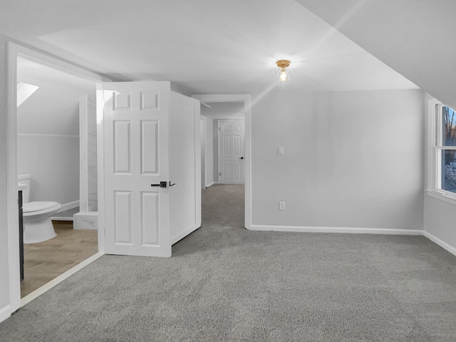 bonus room with carpet flooring and baseboards