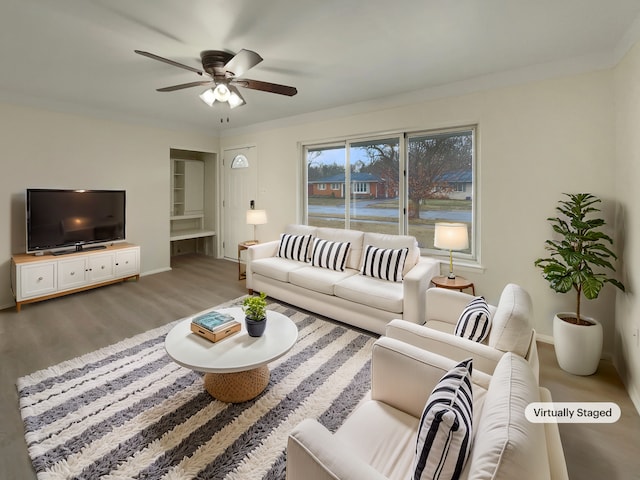 living area with ceiling fan, baseboards, and wood finished floors