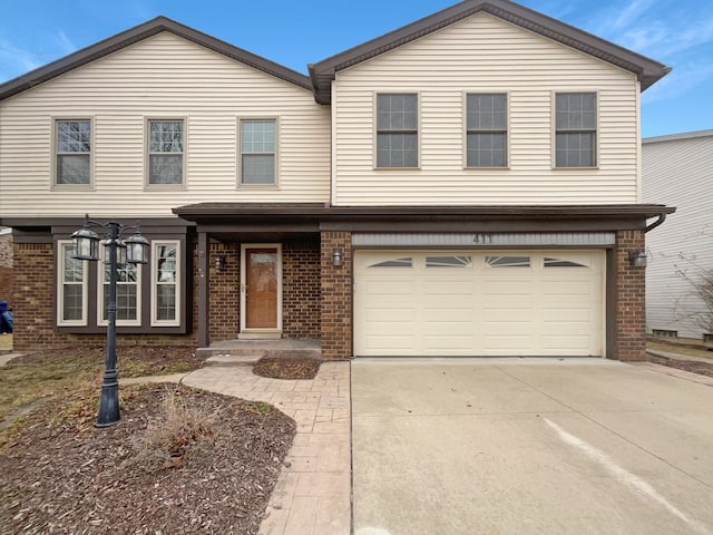 view of front of property with brick siding, an attached garage, and concrete driveway