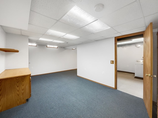 finished below grade area featuring washer / dryer, carpet flooring, a paneled ceiling, and baseboards