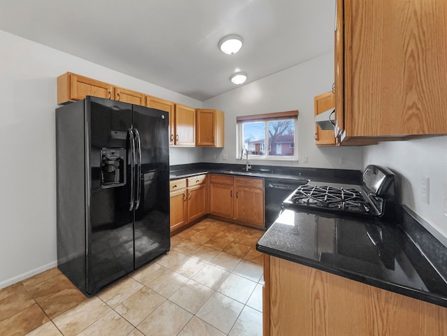 kitchen featuring extractor fan, dishwasher, black fridge, range, and a sink