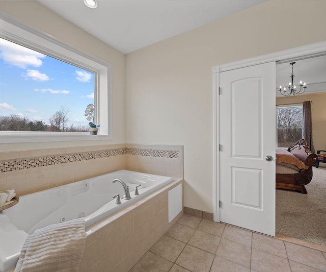 full bathroom with tile patterned floors, connected bathroom, a jetted tub, and a chandelier