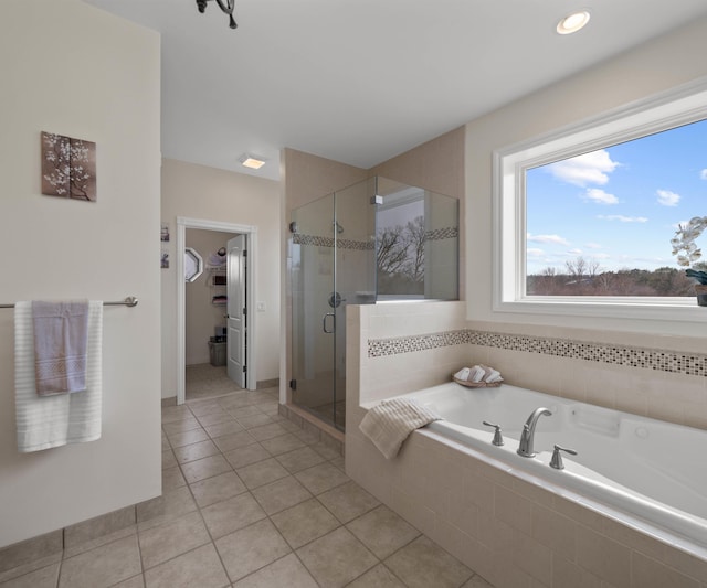 full bath featuring tile patterned floors, a spacious closet, a bath, and a stall shower