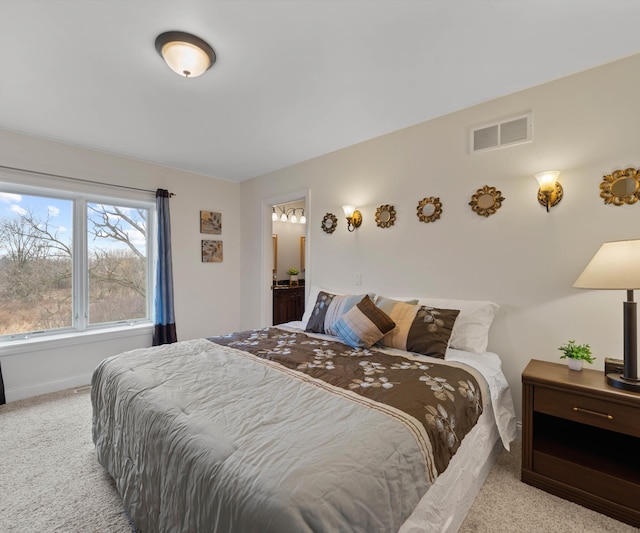 carpeted bedroom featuring visible vents and baseboards