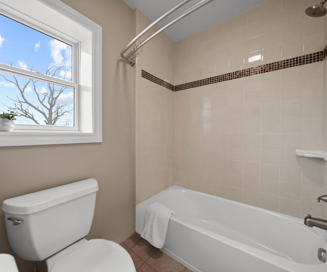 bathroom featuring tile patterned floors, toilet, and  shower combination