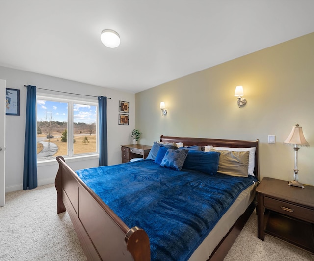 bedroom featuring light carpet and baseboards