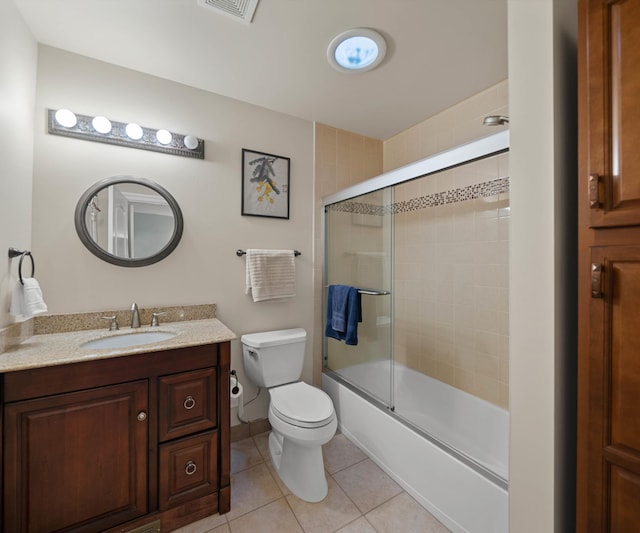 bathroom featuring vanity, visible vents, tile patterned floors, toilet, and combined bath / shower with glass door