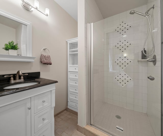 full bathroom with a stall shower, vanity, and tile patterned flooring