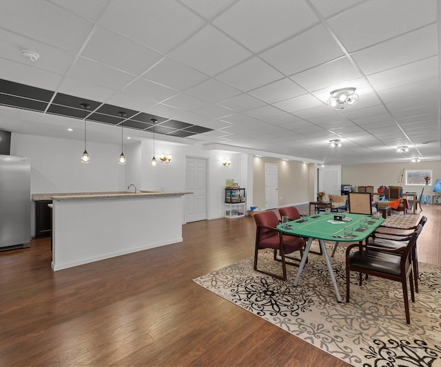 rec room featuring a sink, a paneled ceiling, and dark wood-style flooring