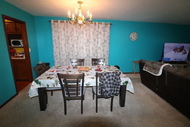 carpeted dining space with a notable chandelier