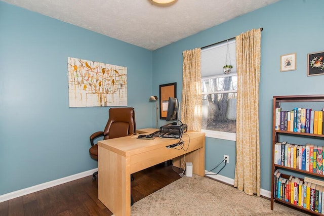 office space featuring baseboards, a textured ceiling, and wood finished floors