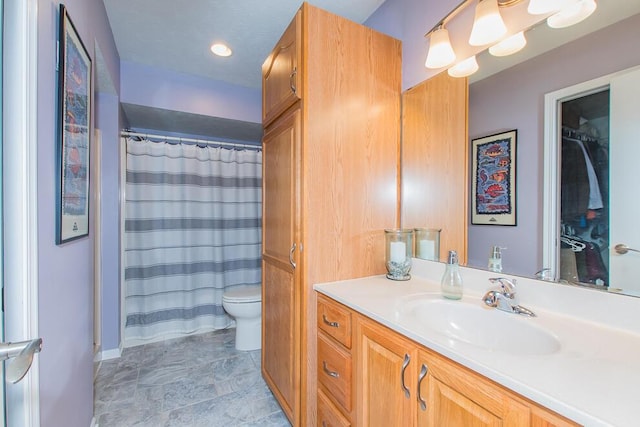 full bath with vanity, curtained shower, and toilet