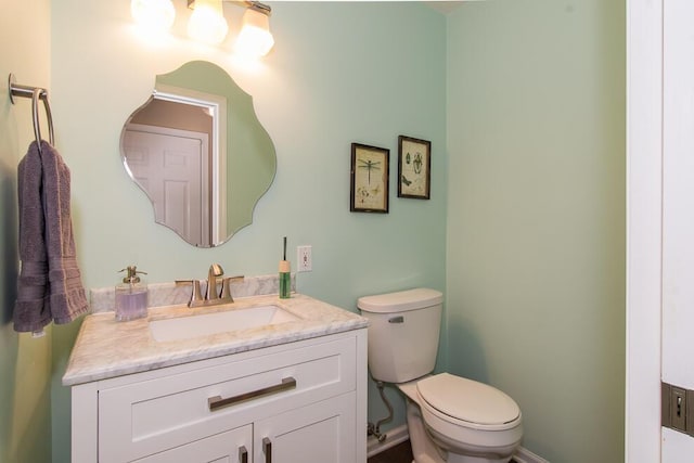 bathroom featuring toilet and vanity