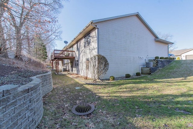 view of home's exterior featuring a deck and a lawn