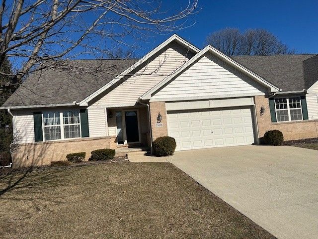 single story home with driveway and a garage