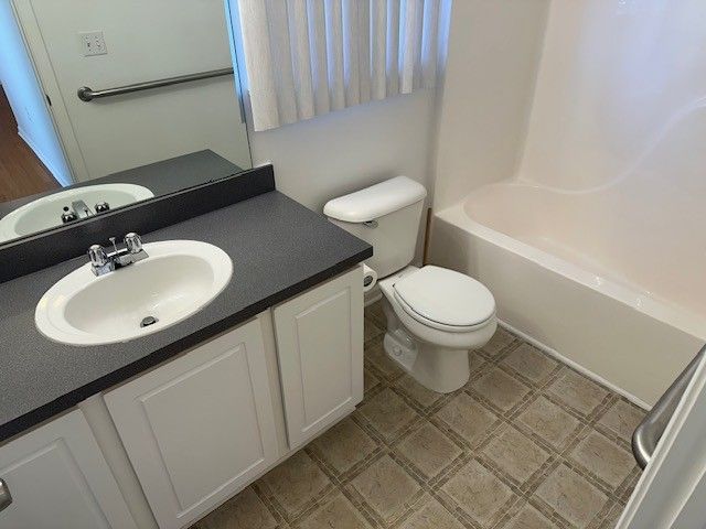 bathroom with tile patterned floors, toilet, and vanity