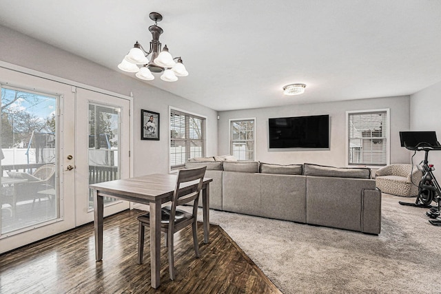 dining area featuring an inviting chandelier and wood finished floors