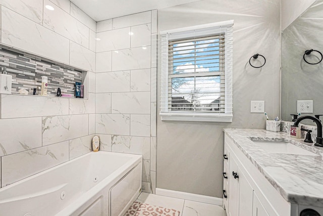 full bathroom featuring vanity, a combined bath / shower with jetted tub, and baseboards