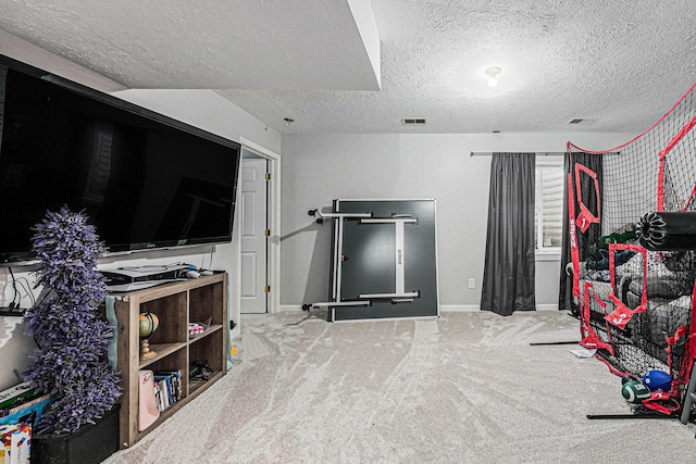 playroom featuring baseboards, visible vents, carpet floors, and a textured ceiling