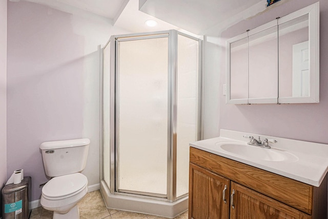 full bathroom with toilet, a shower stall, tile patterned flooring, baseboards, and vanity