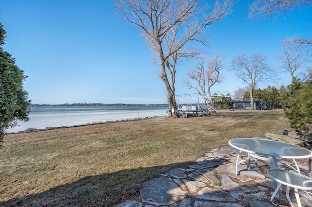 view of yard with a patio and a water view