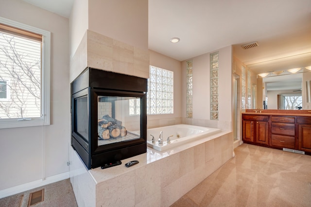 bathroom with a shower stall, a bath, visible vents, and plenty of natural light