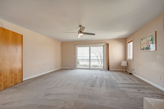 unfurnished room with carpet flooring and baseboards