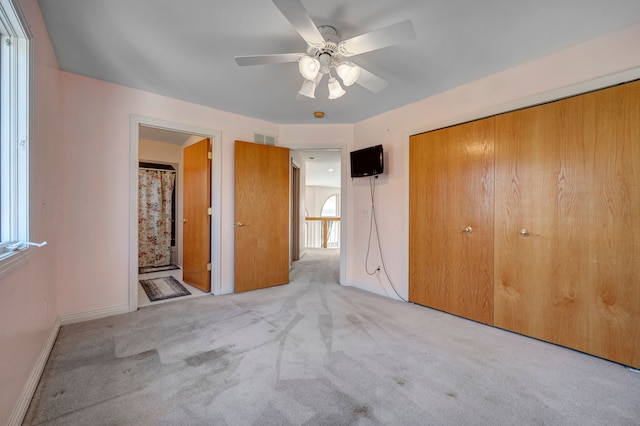 unfurnished bedroom featuring carpet flooring, baseboards, visible vents, and a closet